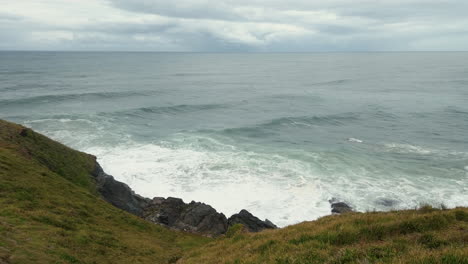 high angle view of waves crashing against rocks at lighthouse beach in port macquarie, australia - high angle shot