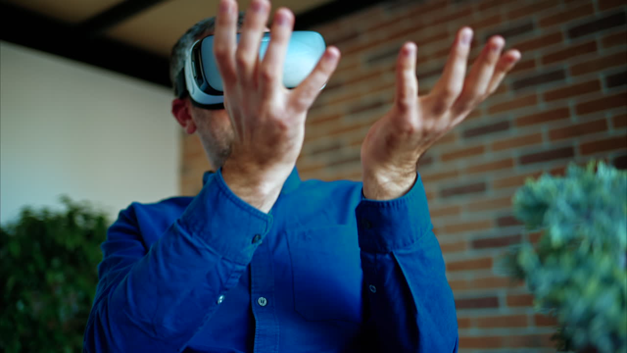 Man gesturing while using a Virtual Reality headset in an office