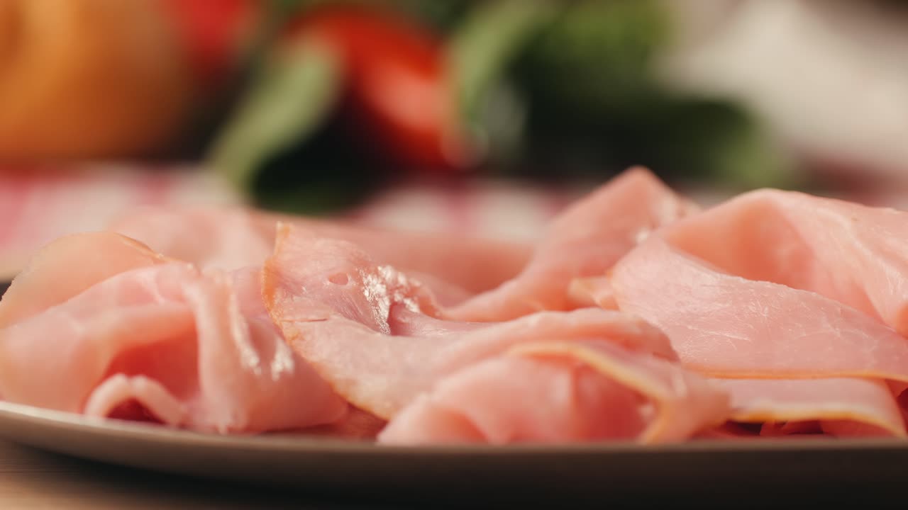 Mortadella ham sandwich, Traditional italian focaccia filled with thin pesto slices of mortadella, served by chef man in cafe restaurant. Macro of traditional italian spanish tapas antipasti.