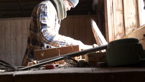 male doing hobby woodworking inside workshop shed, slider, medium