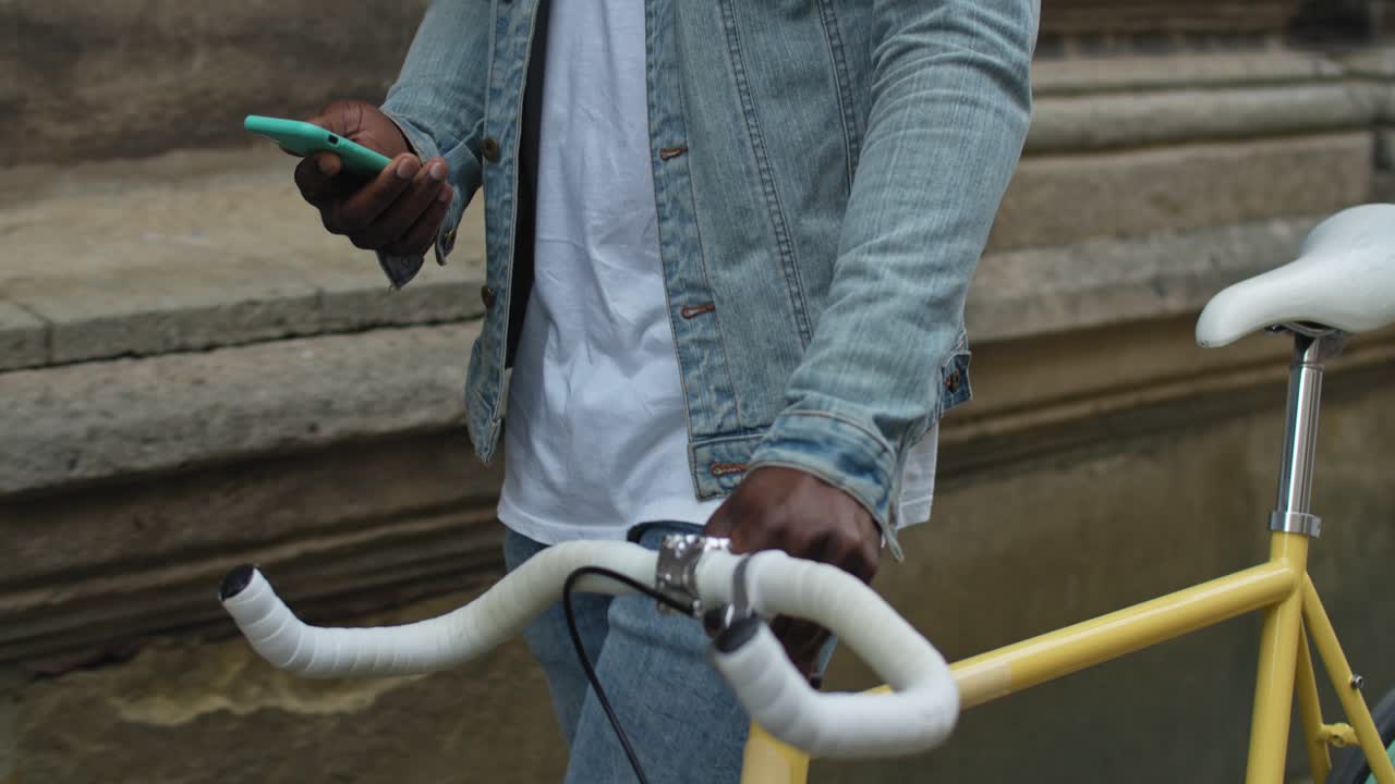 Person with a bicycle using a smartphone