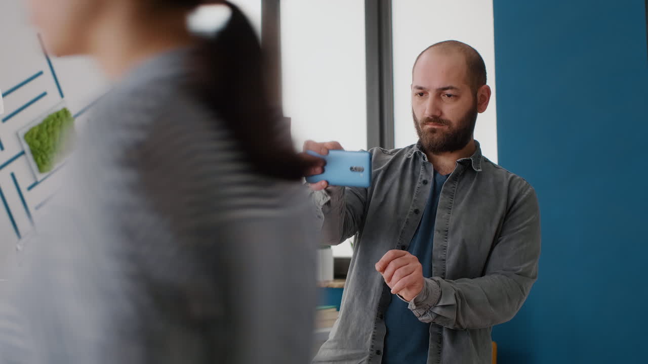 Man using smartphone near architecture model