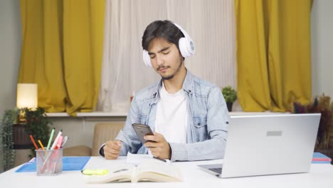 Male-student-using-phone-while-dancing.