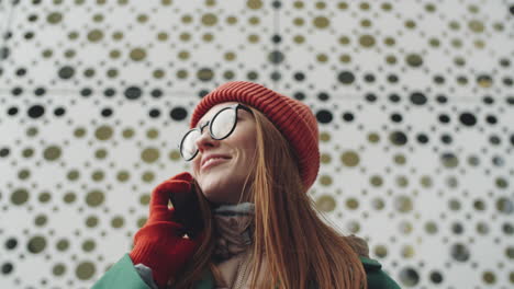 woman talking on phone outdoors in winter