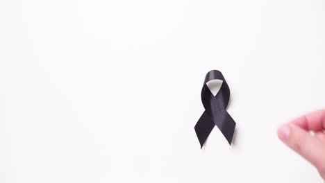 black awareness ribbon on gray background