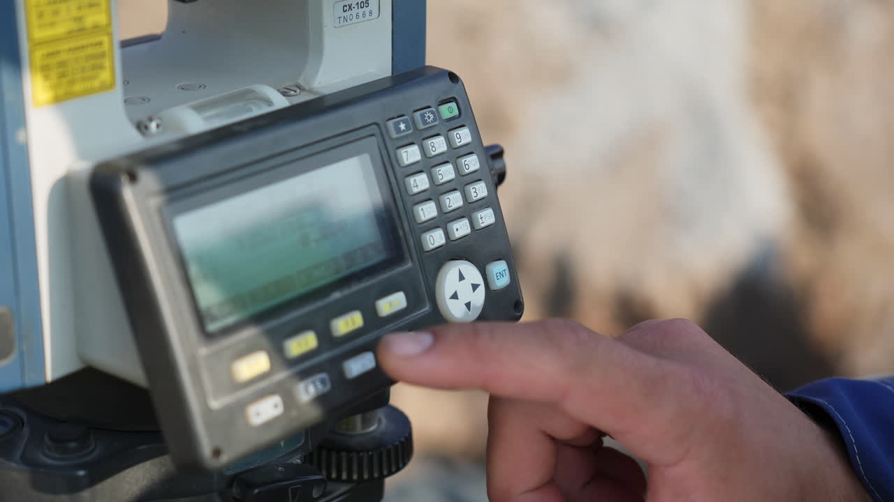 Close-up of a Surveyor Operating a Total Station