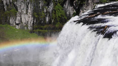 still shot of a beautiful rainbow over the upper mesa falls waterfall