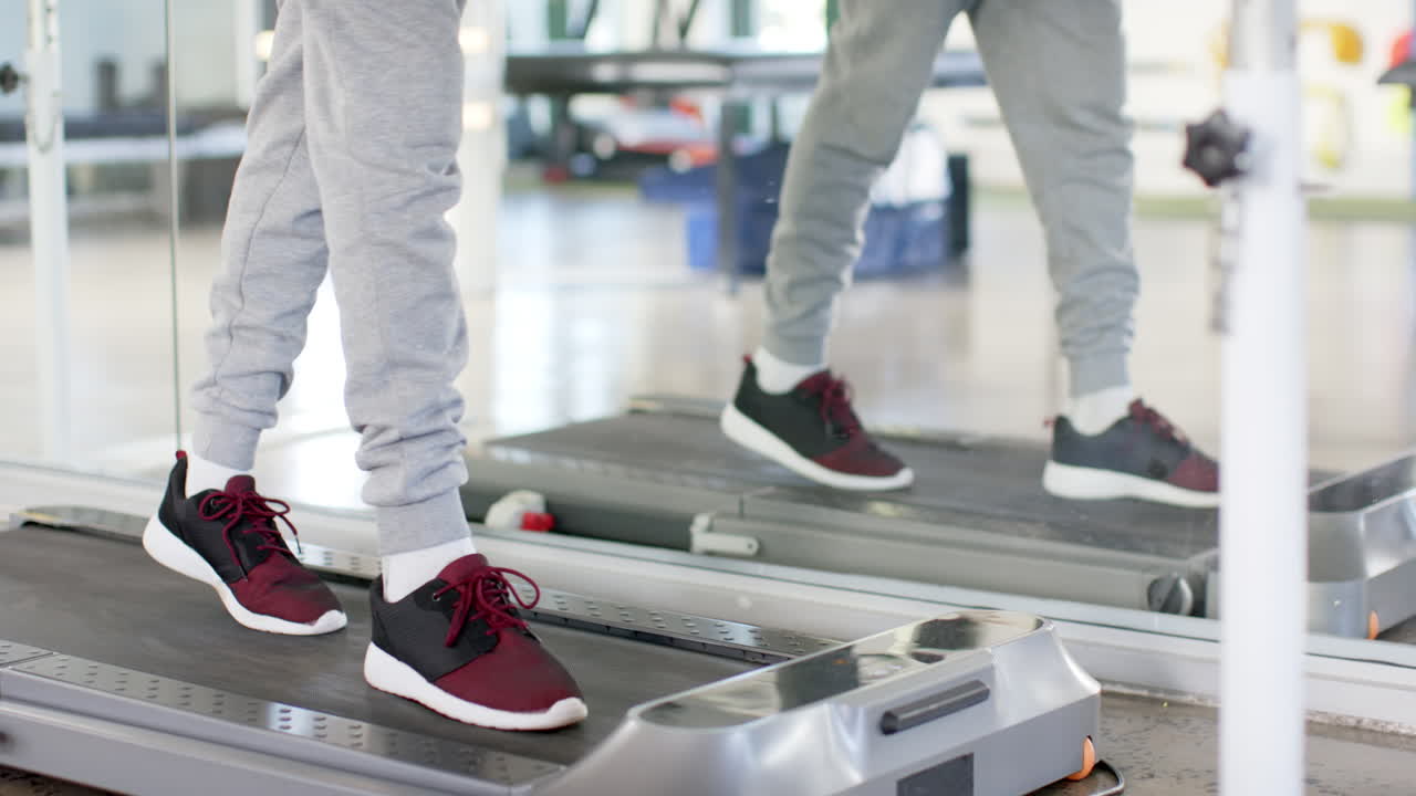 Walking on treadmill, man during rehabilitation therapy session
