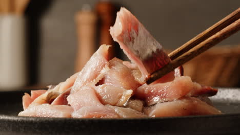 preparing sashimi with chopsticks