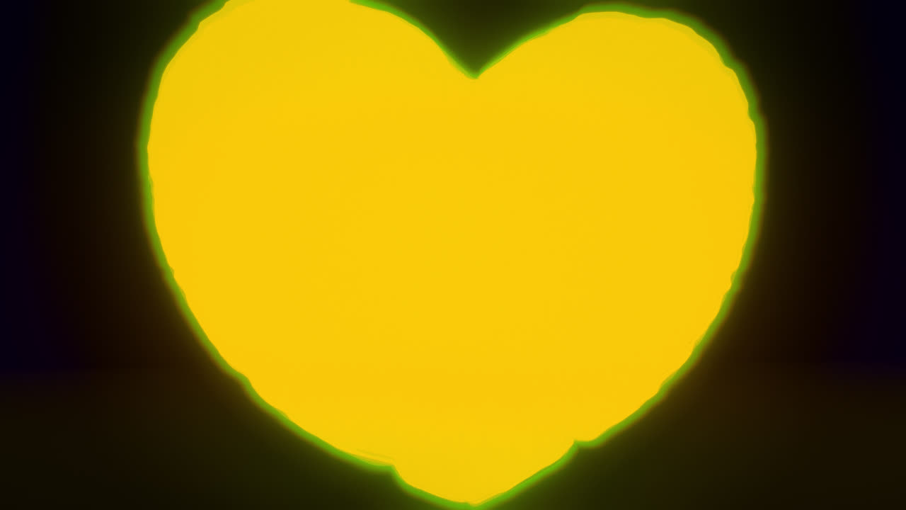 Yellow energy heart shapes on a dark background