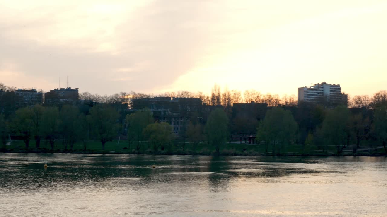 Pan right from "Saint Michel" bridge to "Pont Neuf" bridge in Toulouse, France, at sunset.