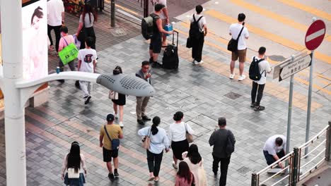 people walking and interacting at a crosswalk