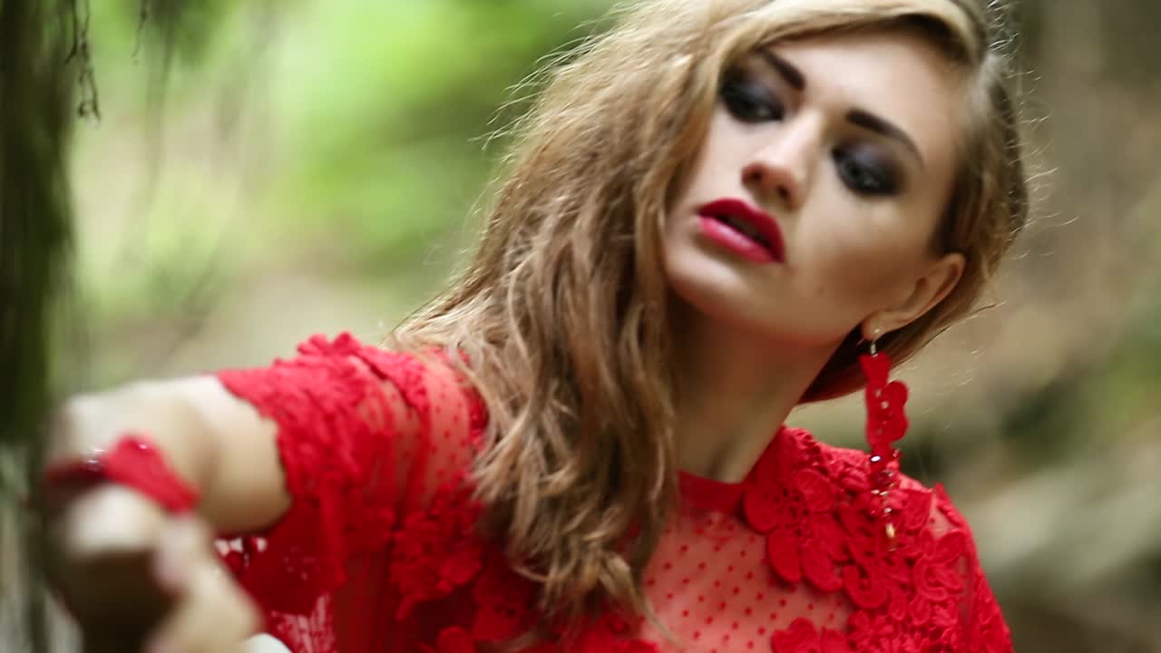 Gorgeous Lady In A Mysterious Foggy Forest. Gorgeous lady in long red dress in a mysterious foggy forest