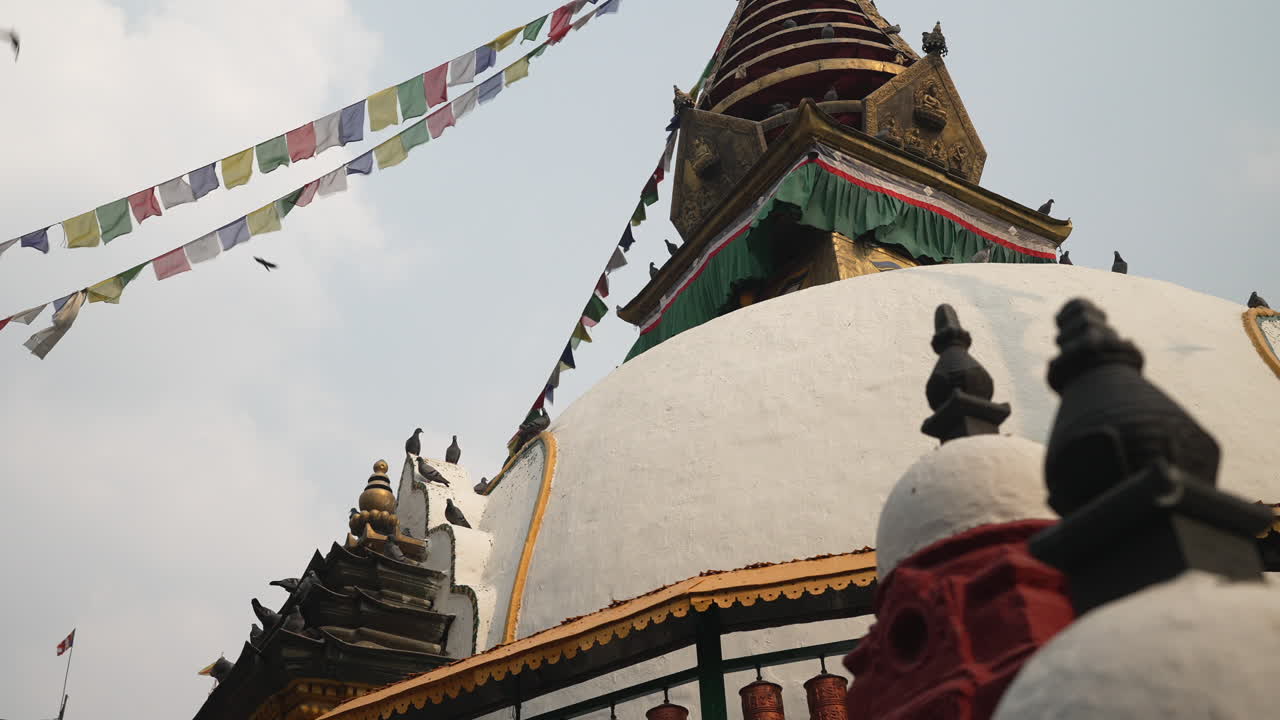 Slow pan in front of a Stupa Temple in Kathmandu Nepal while doves fly around