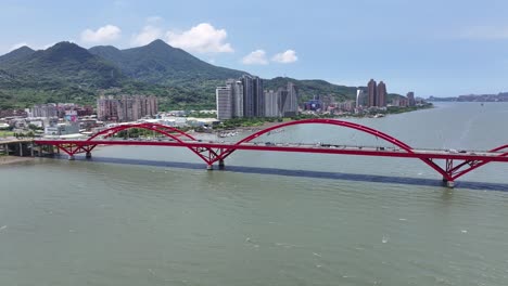 Traffic-over-arched-red-bridge-in-Taipei-City