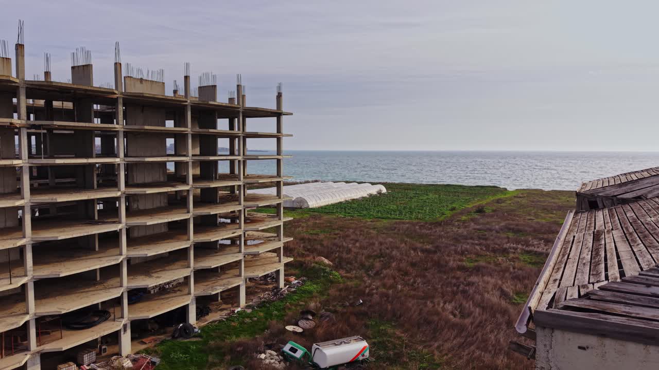 Aerial view of abandoned buildings near the coast with landscape