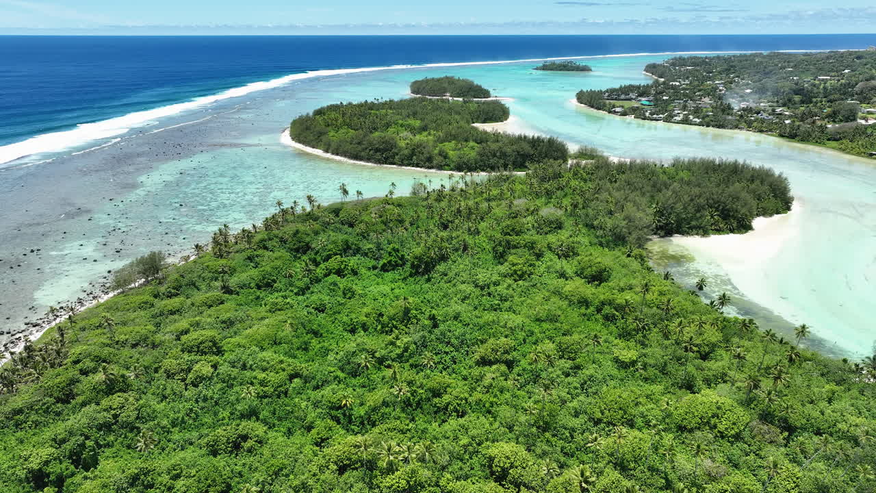 Aerial tracking left out to fringing reef, establishing view of Muri Lagoon Cook Islands Rarotonga