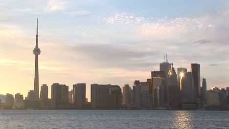 the sun reflects off several buildings in this toronto skyline shot