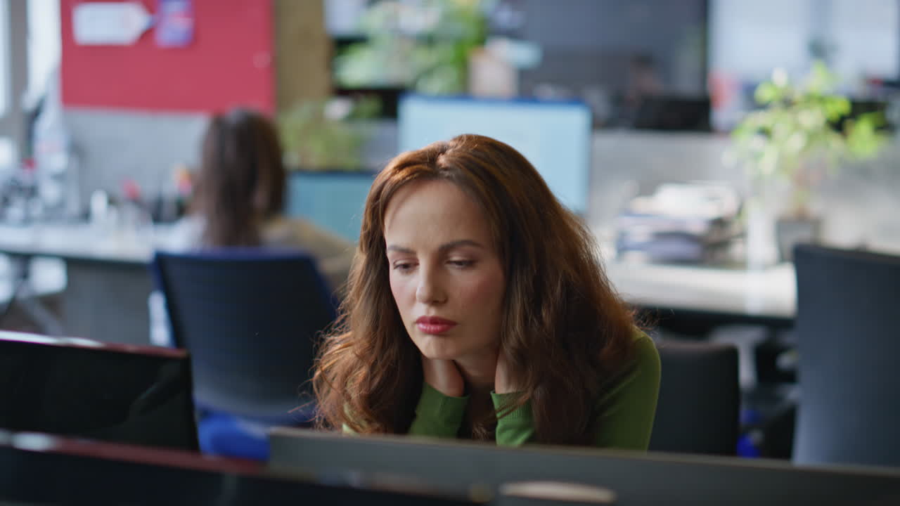 Focused manager using pc working office at open space closeup. Exhausted woman