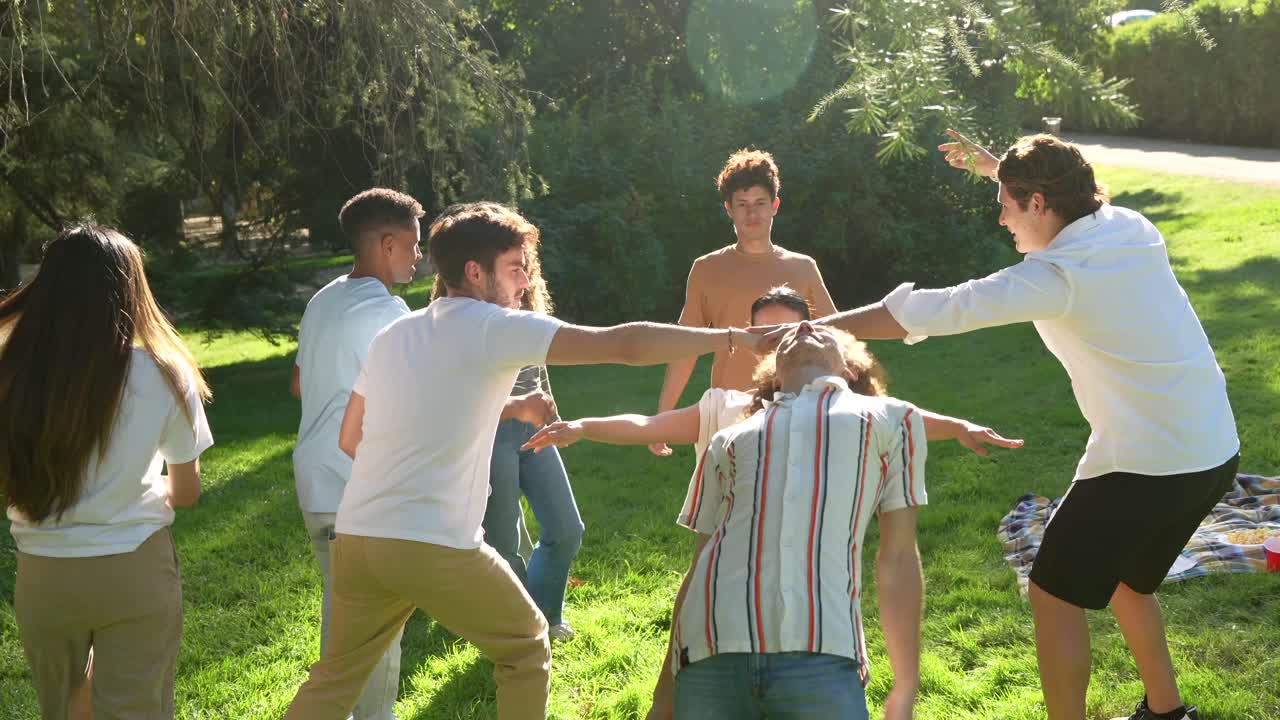Group of Young People Enjoying a Picnic in the Park