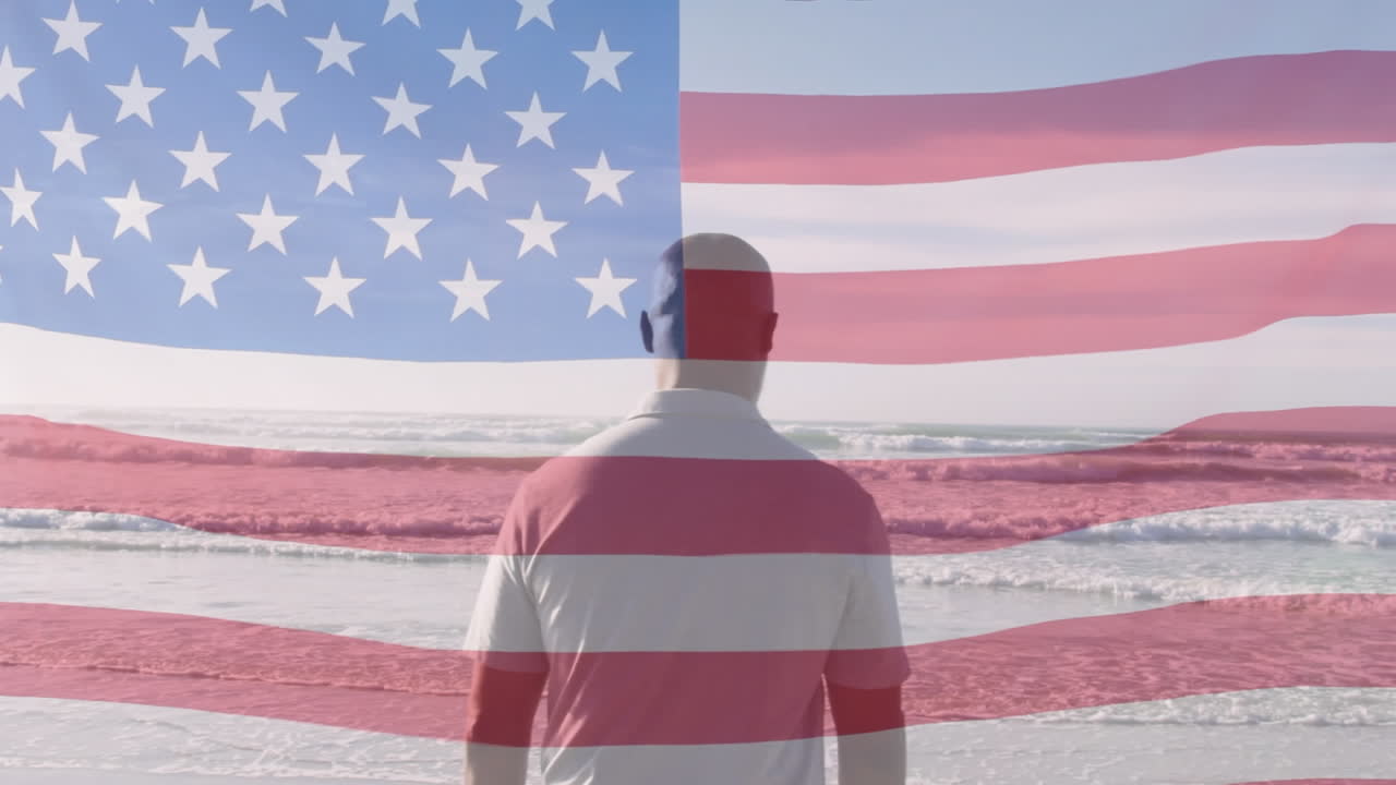 animación de la bandera de los estados unidos de américa sobre un hombre afroamericano en la playa