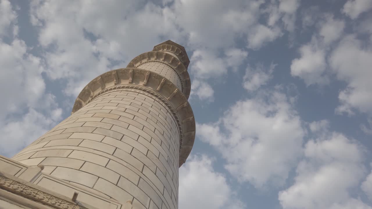 Graceful Tracking Shot of Minaret of Taj Mahal against cloudy sky at Agra, Agravanam, Yamuna River, Uttar Pradesh, India.