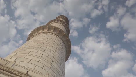 Graceful Tracking Shot of Minaret of Taj Mahal against cloudy sky at Agra, Agravanam, Yamuna River, Uttar Pradesh, India.