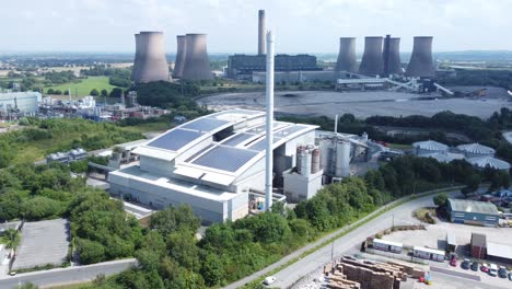 clean solar rooftop installation on modern office building aerial view with coal power station in background orbit left