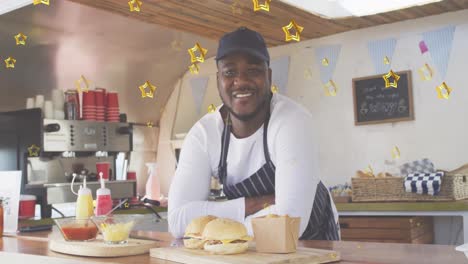 Animation-of-gold-stars-over-happy-african-american-male-food-vendor-in-food-truck