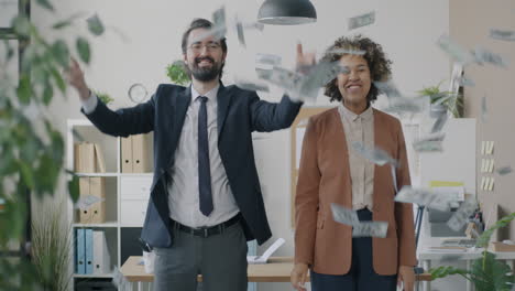 business colleagues celebrating success with money rain