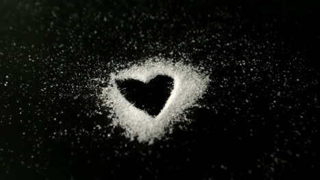 Heart-drawn-into-sugar-being-blown-out-by-wind