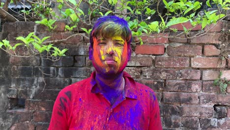 video of a boy after playing holi, zoomed out