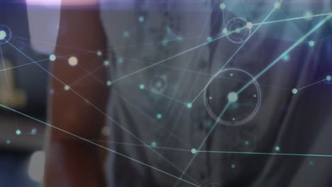 animation of network of connections over caucasian businesswoman using vr goggles in office