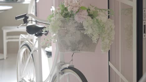 white bicycle with floral basket