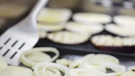 Flipping-onions-on-outside-kitchen