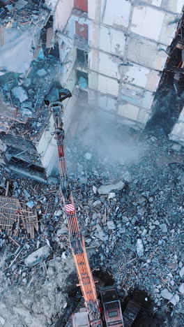 construction of destroyed house. destructive demolition building by excavator. vertical video