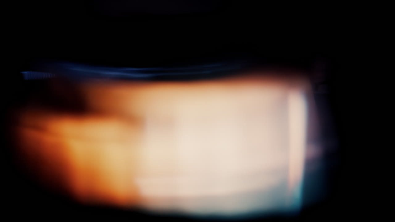 Abstract composition with blurred, soft transitions between warm orange and cool blue tones against a dark background