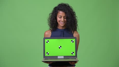 young beautiful hispanic businesswoman showing laptop