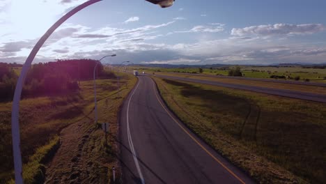 parked semi truck by highway approached sun flare