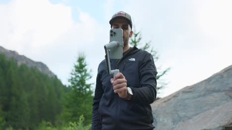man using an insta360 flow gimbal with his iphone - medium shot