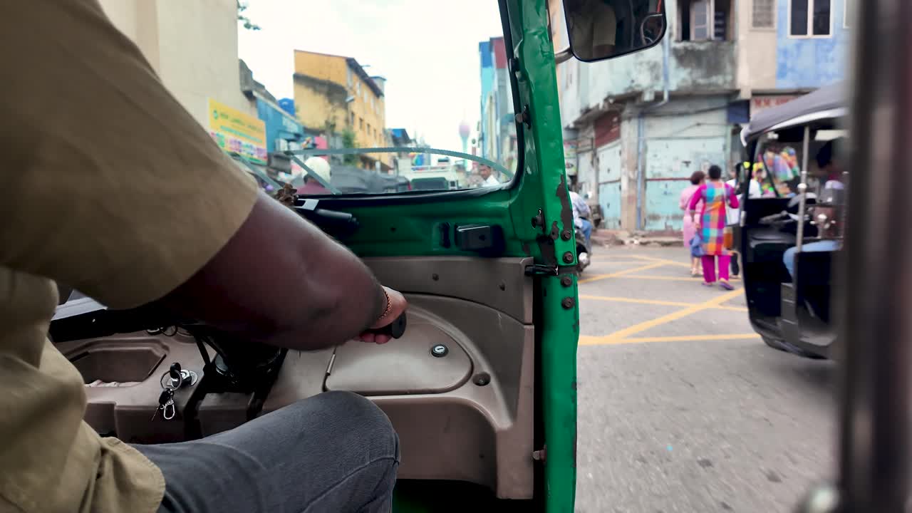 Tuk tuk driver maneuvering through the vibrant streets of colombo, offering a unique perspective of sri lankan daily life