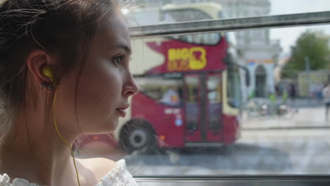 young woman looking out bus window