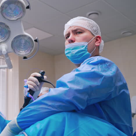 doctor and nurse perform complex operation. portrait of a surgeon in mask during operation. laparoscopic surgery in clinic. medicine concept.
