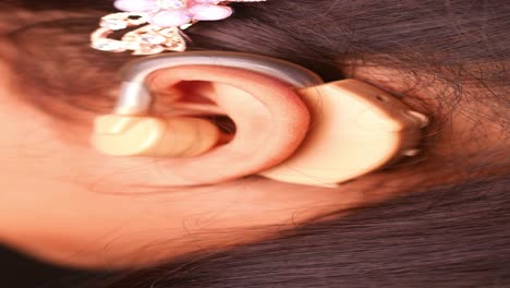 close-up of a woman wearing a hearing aid