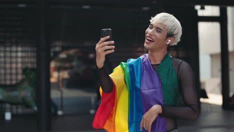 person using smartphone with pride flag
