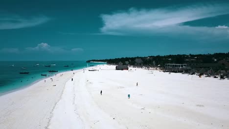 Calmer-aerial-flight-backwards-panorama-over-view-drone-shot-of-a-luxury-resort-hotel-on-a-scenic-tropical-island-on-zanzibar,-africa-2019