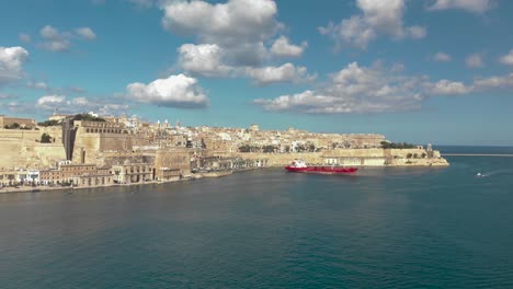 aerial shot over an old city surrounded with sea and a harbour