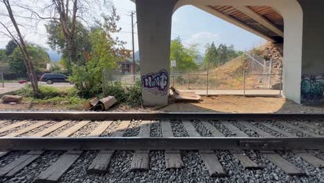 graffiti in an underpass next to a railway