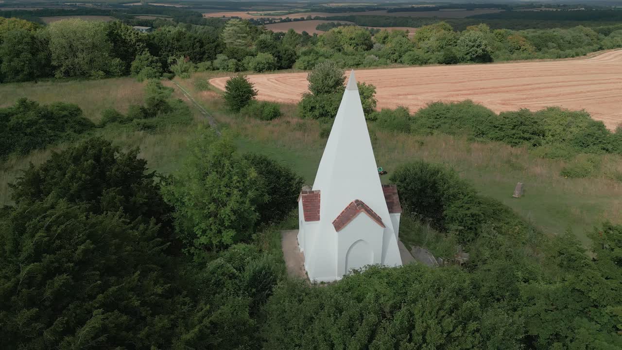 Aerial view pull back reveal Farley mount monument burial marker on Hampshire country park hilltop
