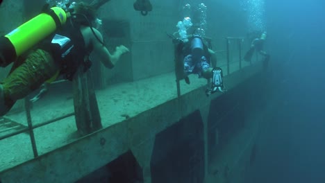 divers explore a shipwreck 2